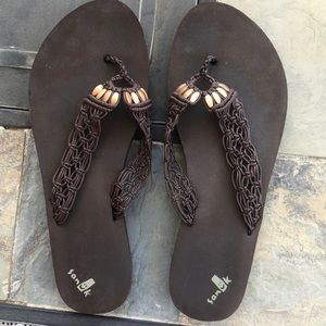Sanuk brand brown flip flops, size 7.